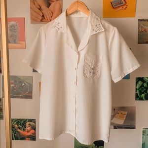 This is a white vintage button-down elegant shirt.